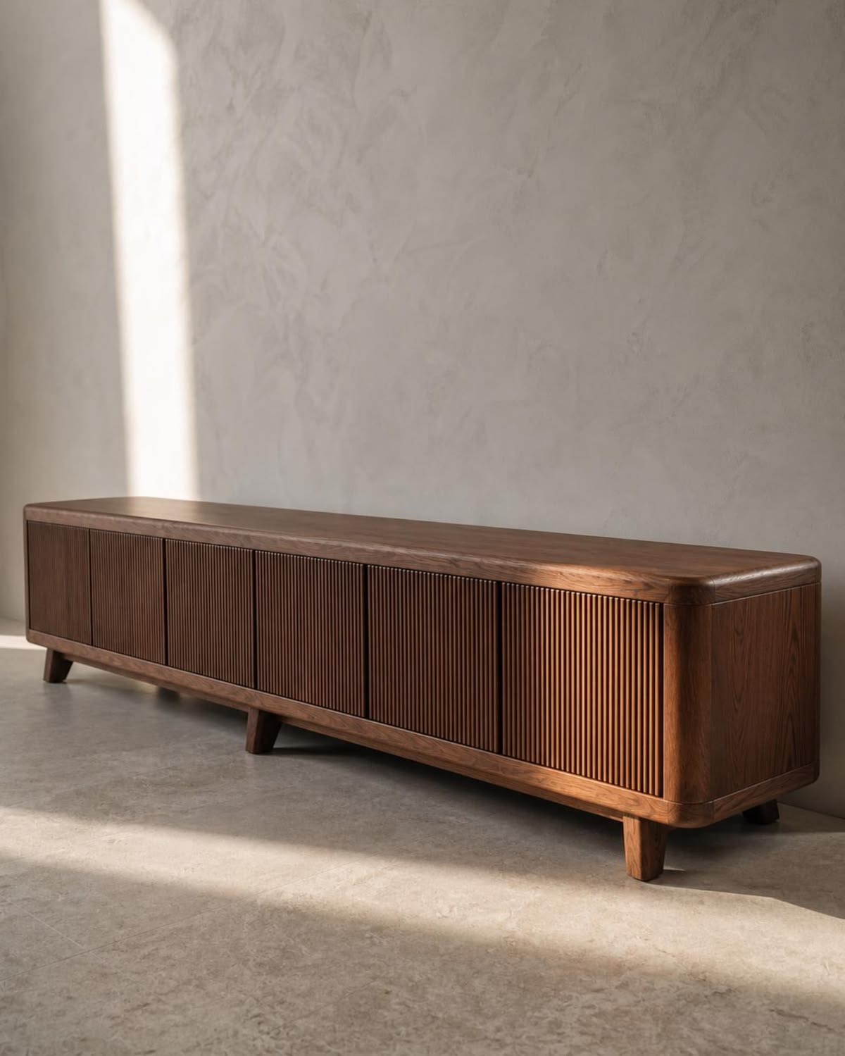 Low wooden media console with fluted doors, rounded corners and short wooden legs
